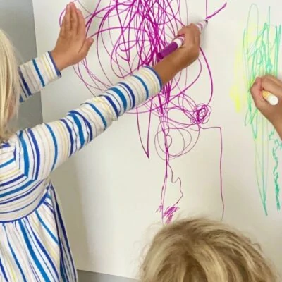 Child drawing big and little marks
