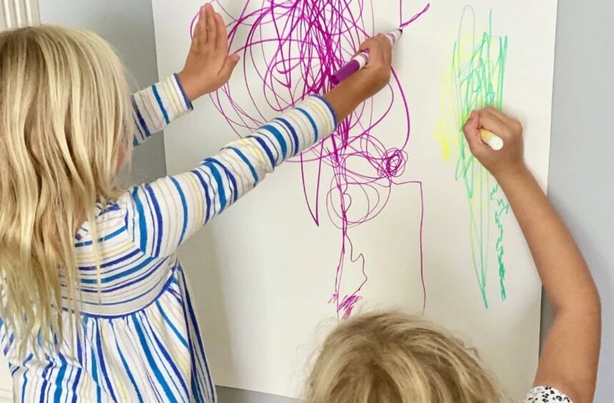 Child drawing big and little marks