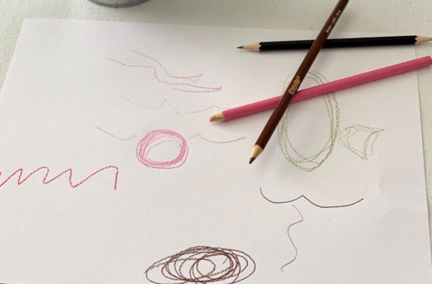 Child makes marks by listening to a story