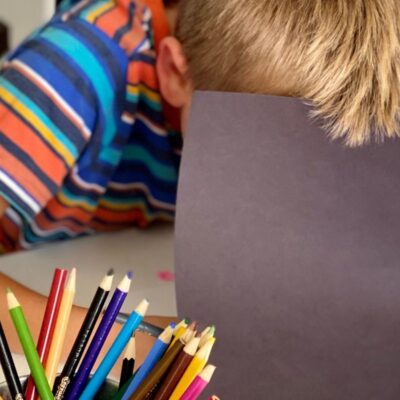 Child makes secret marks by marking in hidden book