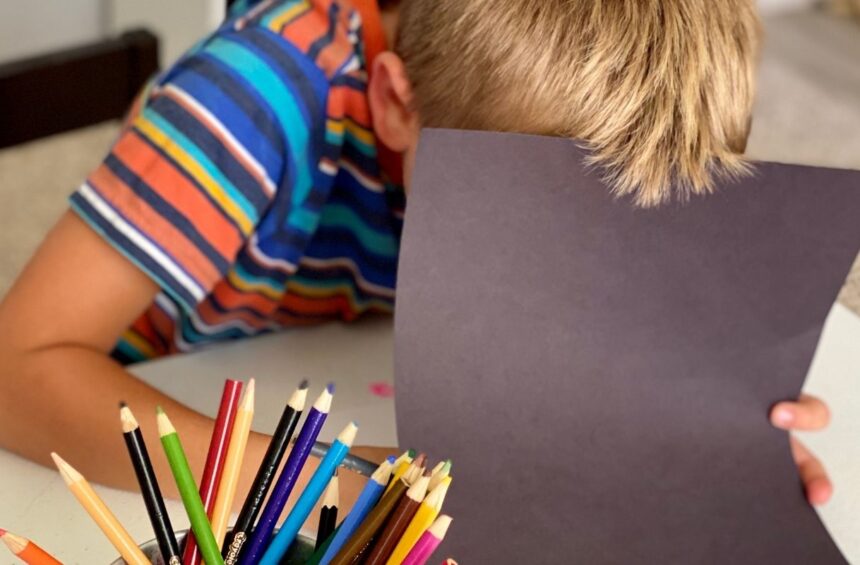 Child makes secret marks by marking in hidden book