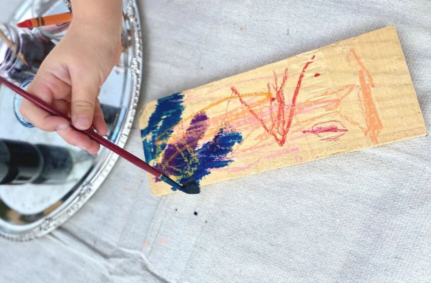 Child painting on piece of wood
