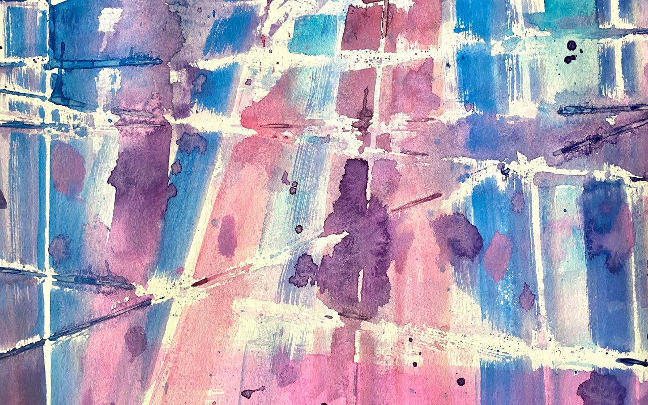 Child painting over rubber band secured to a paper