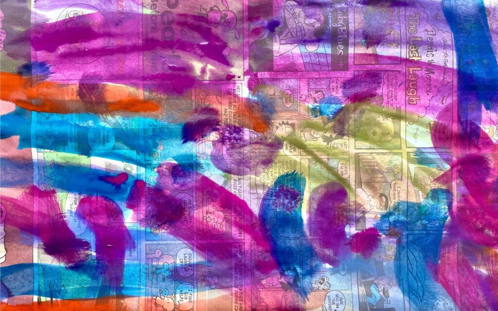Child painting on newspaper