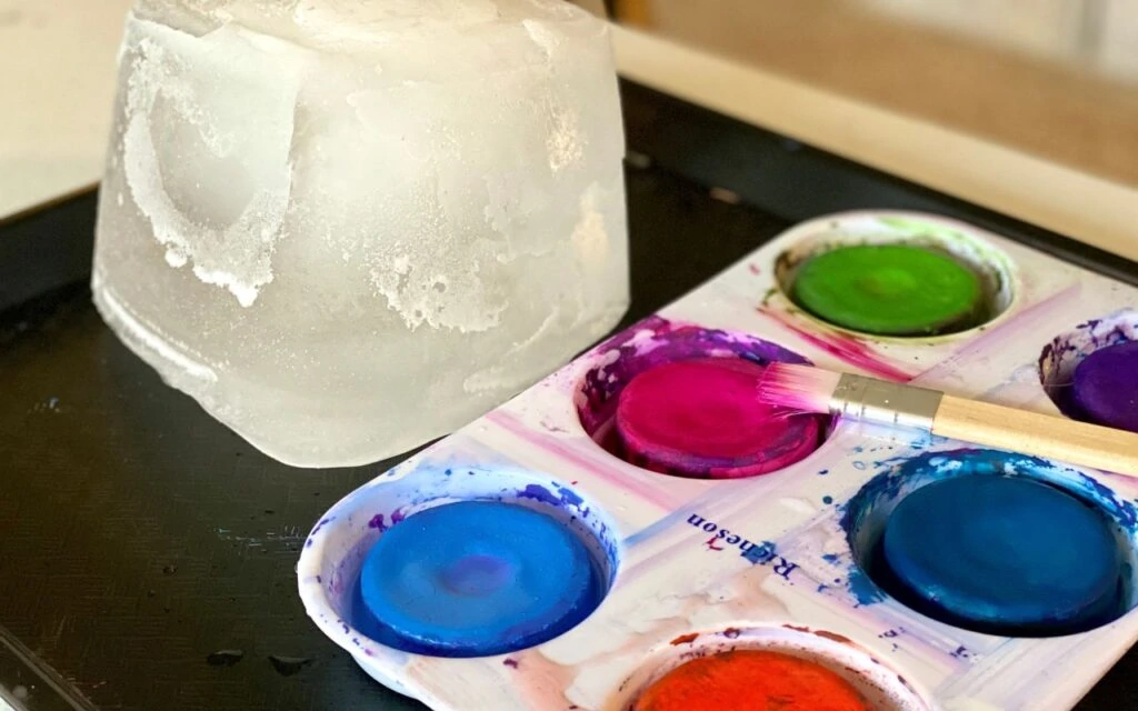 Materials for child to paint on large ice block