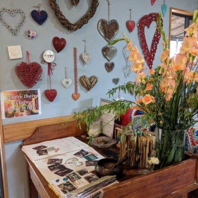 parent sign in desk with flowers and natural wooden elements