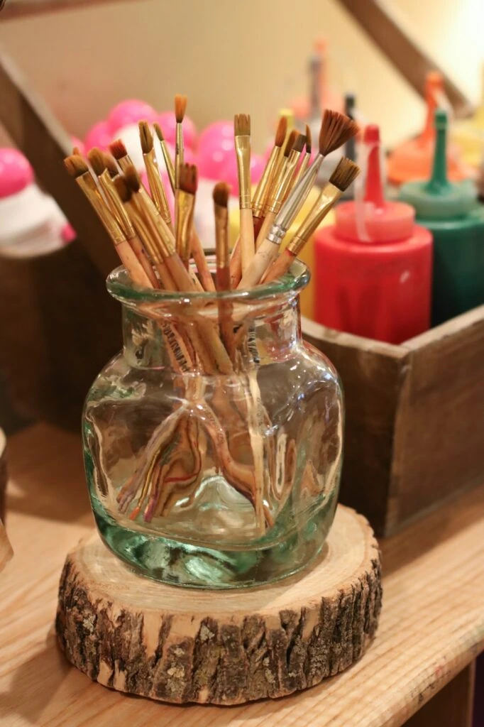 vase on top of the wood cookie for paintbrushes