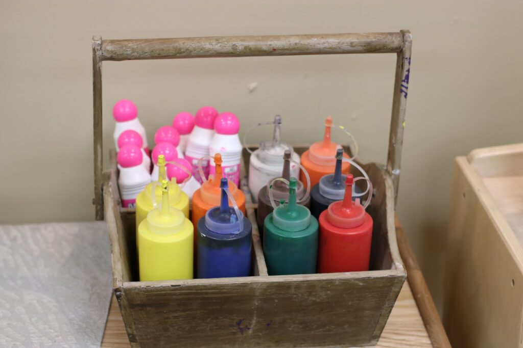 wood bottle crate for tempera paint storage in clear ketchup bottles